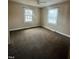 Bedroom with carpet flooring, neutral paint color, two windows and ceiling fan at 1641 Bridgedale Dr, Rocky Mount, NC 27803