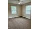 Bedroom with carpet flooring, neutral paint color, two windows and ceiling fan at 1641 Bridgedale Dr, Rocky Mount, NC 27803