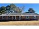 Brick ranch house with a spacious lawn and mature trees at 1641 Bridgedale Dr, Rocky Mount, NC 27803