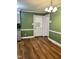 Charming eat-in kitchen with hardwood floors, open doorway, and white trim accents at 1641 Bridgedale Dr, Rocky Mount, NC 27803
