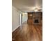 Spacious living room featuring a brick fireplace, hardwood floors, and access to other rooms at 1641 Bridgedale Dr, Rocky Mount, NC 27803