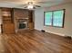 Cozy living room with brick fireplace, built-in shelving, and natural light, ideal for relaxation at 1641 Bridgedale Dr, Rocky Mount, NC 27803