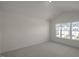 Well-lit bedroom with a large window overlooking houses at 184 Starlight St, Sanford, NC 27330