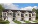 New townhome community featuring multiple units with attached garages and landscaping at 184 Starlight St, Sanford, NC 27330
