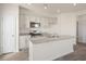 Modern kitchen with white cabinets, granite countertops, and stainless steel appliances at 184 Starlight St, Sanford, NC 27330