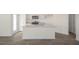 Modern kitchen with island, granite countertops, and stainless steel appliances at 184 Starlight St, Sanford, NC 27330