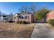 Brick home with a driveway and mature trees in the yard at 210 Earl St, Rocky Mount, NC 27804