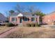 Brick home with a charming front porch and well-maintained landscaping at 210 Earl St, Rocky Mount, NC 27804