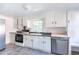 Kitchen with white cabinets, stainless steel appliances, and a window at 210 Earl St, Rocky Mount, NC 27804