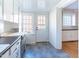 Kitchen with white cabinets, a back door, and grey tile floors at 210 Earl St, Rocky Mount, NC 27804