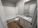 Clean bathroom with single vanity, granite countertop, and tub at 262 Starry Sky Dr, Benson, NC 27504