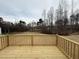 Wooden deck overlooking a wooded backyard at 262 Starry Sky Dr, Benson, NC 27504