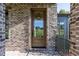 Wooden front door with glass panels and black hardware at 289 Gaines Trl, Pittsboro, NC 27312