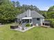 Inviting backyard patio with hot tub and an outdoor seating area perfect for entertaining at 265 Verde Rd, Apex, NC 27523