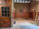 Inside a barn with a door, light fixtures and stained wood plank walls at 265 Verde Rd, Apex, NC 27523
