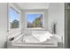 Bathroom with a large corner soaking tub and bright windows at 265 Verde Rd, Apex, NC 27523