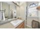 Bathroom with vanity, large mirror, and arched window at 265 Verde Rd, Apex, NC 27523