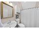 Cozy bathroom with a vanity, mirror, toilet, and shower with a curtain at 265 Verde Rd, Apex, NC 27523