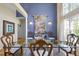 Elegant dining area with a glass table, wooden chairs, and custom wall décor at 265 Verde Rd, Apex, NC 27523