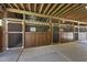 View of horse barn featuring wooden stalls with brick and concrete floors at 265 Verde Rd, Apex, NC 27523