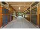 Picturesque horse barn featuring wooden stalls and a spacious aisleway for ease of movement at 265 Verde Rd, Apex, NC 27523