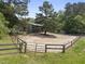 Exterior shot of a horse lot with a wooden fence surrounding a large dirt clearing at 265 Verde Rd, Apex, NC 27523
