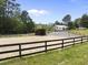 Exterior shot of horse lot featuring a fenced area with dirt and horse barns at 265 Verde Rd, Apex, NC 27523