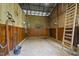 Inside horse stall with concrete floor and wooden wall and a ladder at 265 Verde Rd, Apex, NC 27523