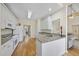 Kitchen with white cabinets, granite counters, and hardwood floors at 265 Verde Rd, Apex, NC 27523