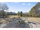 Stone patio with wrought iron furniture, offering a serene view of the property at 265 Verde Rd, Apex, NC 27523