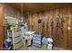 Tack room with knotty pine, storage shelves, utility sink, and equipment racks at 265 Verde Rd, Apex, NC 27523