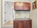 Wet bar with wood cabinets, granite countertop, wine glass racks, and a small sink at 265 Verde Rd, Apex, NC 27523