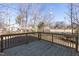 New wooden back deck with railings offering an outdoor space for relaxing and entertaining with wooded view at 343 Foster St, Burlington, NC 27217