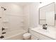 Bright bathroom featuring a shower-tub combo with sleek fixtures and a modern vanity with clean lines at 343 Foster St, Burlington, NC 27217