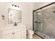 Modern bathroom with a glass-enclosed shower and tile, alongside a white vanity with a sleek mirror at 343 Foster St, Burlington, NC 27217