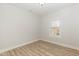 Cozy bedroom with wood-look flooring and a window offering natural light, showcasing a calm and neutral palette at 343 Foster St, Burlington, NC 27217
