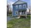 Charming two-story home with light blue siding, covered front porch, and a gravel driveway at 343 Foster St, Burlington, NC 27217