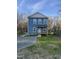 Charming two-story home featuring light blue siding, a covered front porch, and a well-maintained lawn at 343 Foster St, Burlington, NC 27217