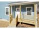 Inviting front porch with white railing, wooden steps, and the house number displayed at 343 Foster St, Burlington, NC 27217