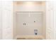 Spacious laundry room closet with white shelving, connections for washer and dryer, and double door entry at 343 Foster St, Burlington, NC 27217