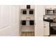Walk-in pantry with white shelves and ample storage space next to stainless steel microwave at 343 Foster St, Burlington, NC 27217