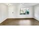 Bright living room featuring hardwood floors and large window at 3743 Bison Hill Ln, Raleigh, NC 27604