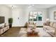 Virtually staged living room with beige sofas and wood floors at 3743 Bison Hill Ln, Raleigh, NC 27604