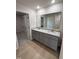 Double vanity bathroom with granite countertop and a large mirror at 39 Shiloh Dr, Lillington, NC 27546