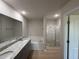 Double vanity bathroom with granite countertops and a soaking tub at 39 Shiloh Dr, Lillington, NC 27546