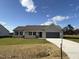 Newly constructed ranch home with gray garage door and stone accents at 39 Shiloh Dr, Lillington, NC 27546