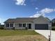 New construction ranch home features a neutral exterior and landscaping at 39 Shiloh Dr, Lillington, NC 27546