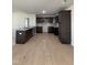 Modern kitchen with dark cabinetry, granite counters, and LVP flooring at 39 Shiloh Dr, Lillington, NC 27546