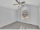 Bedroom with arched window, ceiling fan, and neutral carpet at 3901 La Varra Dr, Clayton, NC 27520