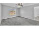 Bedroom with gray carpet, ceiling fan, and window at 3901 La Varra Dr, Clayton, NC 27520